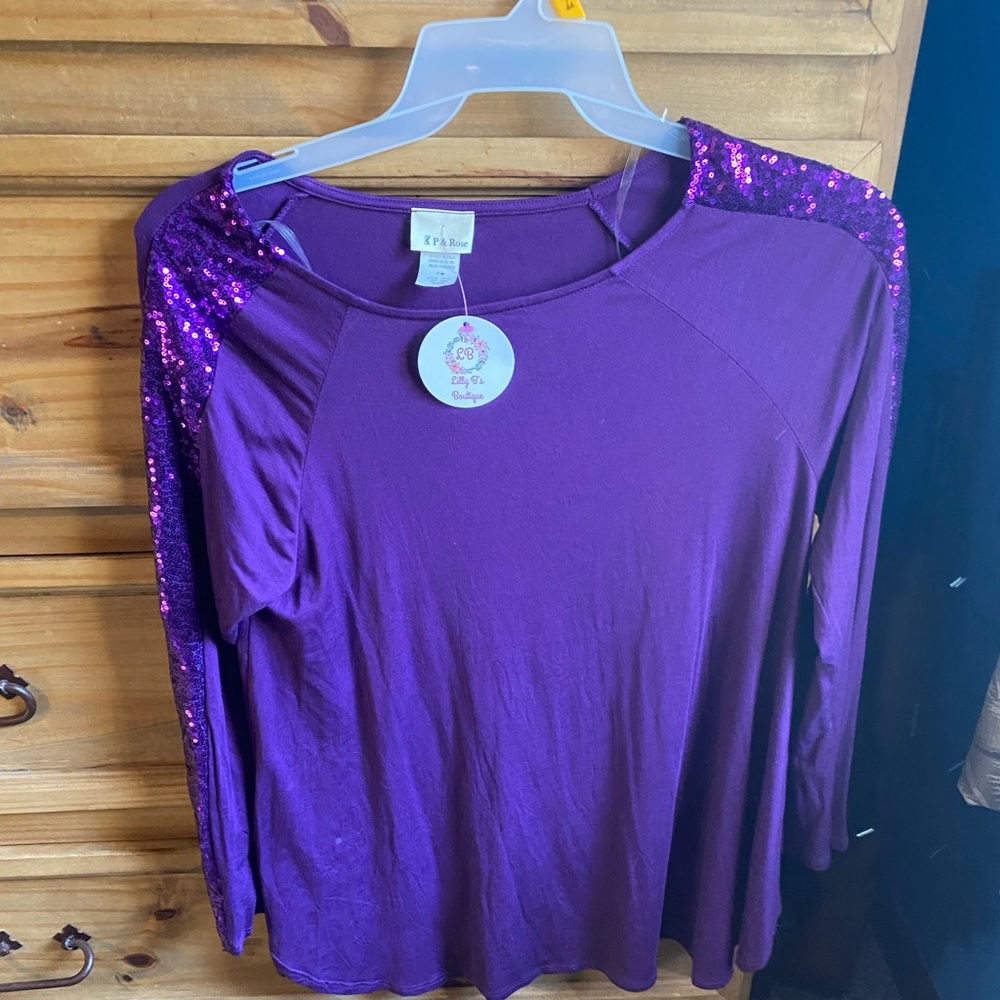Cute purple top with sequin sleeves NWT. Medium